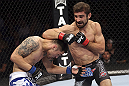 CALGARY, CANADA - JULY 21:  (R-L) Antonio Carvalho exchanges punches with Daniel Pineda during their featherweight bout at UFC 149 inside the Scotiabank Saddledome on July 21, 2012 in Calgary, Alberta, Canada.  (Photo by Nick Laham/Zuffa LLC/Zuffa LLC via Getty Images)