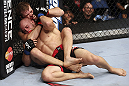 CALGARY, CANADA - JULY 21:  Bryan Caraway attempts to choke out Mitch Gagnon during their bantamweight bout at UFC 149 inside the Scotiabank Saddledome on July 21, 2012 in Calgary, Alberta, Canada.  (Photo by Nick Laham/Zuffa LLC/Zuffa LLC via Getty Images)