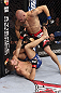 CALGARY, CANADA - JULY 21: (R-L) Mitch Gagnon stands over Bryan Caraway during their bantamweight bout at UFC 149 inside the Scotiabank Saddledome on July 21, 2012 in Calgary, Alberta, Canada.  (Photo by Nick Laham/Zuffa LLC/Zuffa LLC via Getty Images)