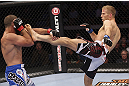 CALGARY, CANADA - JULY 21: (L-R) Court McGee blocks a kick from Nick Ring during their middleweight bout at UFC 149 inside the Scotiabank Saddledome on July 21, 2012 in Calgary, Alberta, Canada.  (Photo by Nick Laham/Zuffa LLC/Zuffa LLC via Getty Images)