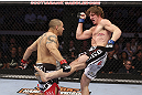 CALGARY, CANADA - JULY 21:  (L-R) Chris Clements takes a kick from Matthew Riddle during their welterweight bout at UFC 149 inside the Scotiabank Saddledome on July 21, 2012 in Calgary, Alberta, Canada.  (Photo by Nick Laham/Zuffa LLC/Zuffa LLC via Getty Images)