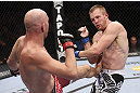 CALGARY, CANADA - JULY 21: (L-R) Brian Ebersole lands a kick at the body of James Head during their welterweight bout at UFC 149 inside the Scotiabank Saddledome on July 21, 2012 in Calgary, Alberta, Canada.  (Photo by Nick Laham/Zuffa LLC/Zuffa LLC via Getty Images)
