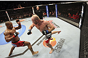 CALGARY, CANADA - JULY 21:  (L-R) Hector Lombard exchanges punches with Tim Boetsch during their middleweight bout at UFC 149 inside the Scotiabank Saddledome on July 21, 2012 in Calgary, Alberta, Canada.  (Photo by Nick Laham/Zuffa LLC/Zuffa LLC via Getty Images)