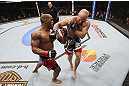 CALGARY, CANADA - JULY 21:  (L-R) Hector Lombard exchanges punches with Tim Boetsch during their middleweight bout at UFC 149 inside the Scotiabank Saddledome on July 21, 2012 in Calgary, Alberta, Canada.  (Photo by Nick Laham/Zuffa LLC/Zuffa LLC via Getty Images)