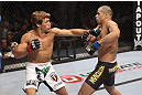 CALGARY, CANADA - JULY 21: (L-R) Urijah Faber throws a punch at Renan Barao during their UFC interim bantamweight championship bout at UFC 149 inside the Scotiabank Saddledome on July 21, 2012 in Calgary, Alberta, Canada.  (Photo by Nick Laham/Zuffa LLC/Zuffa LLC via Getty Images)