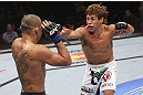 CALGARY, CANADA - JULY 21: (R-L) Urijah Faber throws a punch at Renan Barao during their UFC interim bantamweight championship bout at UFC 149 inside the Scotiabank Saddledome on July 21, 2012 in Calgary, Alberta, Canada.  (Photo by Nick Laham/Zuffa LLC/Zuffa LLC via Getty Images)