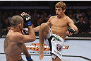 CALGARY, CANADA - JULY 21: (R-L) Urijah Faber attempts a kick to the body of Renan Barao during their UFC interim bantamweight championship bout at UFC 149 inside the Scotiabank Saddledome on July 21, 2012 in Calgary, Alberta, Canada.  (Photo by Nick Laham/Zuffa LLC/Zuffa LLC via Getty Images)