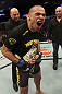 CALGARY, CANADA - JULY 21:  Renan Barao celebrates his victory over Urijah Faber as UFC President Dana White gives him the Championship belt after their UFC interim bantamweight championship bout at UFC 149 inside the Scotiabank Saddledome on July 21, 2012 in Calgary, Alberta, Canada.  (Photo by Nick Laham/Zuffa LLC/Zuffa LLC via Getty Images)