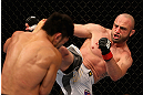LOS ANGELES, CA - AUGUST 04:  Manny Gamburyan (R) kicks Michihiro Omigawa (L) during their Featherweight bout at the UFC on FOX event at Staples Center on August 4, 2012 in Los Angeles, California. Gamburyan defeated Omigawa by unanimous decision.  (Photo by Josh Hedges/Zuffa LLC via Getty Images)