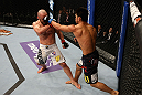 LOS ANGELES, CA - AUGUST 04:  Michihiro Omigawa (R) lands a punch on Manny Gamburyan (L) in his Featherweight bout at the UFC on FOX event at Staples Center on August 4, 2012 in Los Angeles, California.  (Photo by Josh Hedges/Zuffa LLC via Getty Images)