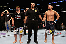 LOS ANGELES, CA - AUGUST 04:  Manny Gamburyan (L) and Michihiro Omigawa (R) await the decision during the UFC on FOX event at Staples Center on August 4, 2012 in Los Angeles, California.  (Photo by Josh Hedges/Zuffa LLC via Getty Images)