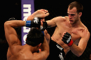 LOS ANGELES, CA - AUGUST 04:  Cole Miller (R) kicks Nam Phan in their featherweight bout during UFC on FOX at Staples Center on August 4, 2012 in Los Angeles, California.  Phan defeated Miller by split decision.  (Photo by Josh Hedges/Zuffa LLC via Getty Images)