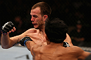 LOS ANGELES, CA - AUGUST 04:  Cole Miller is hit by Nam Phan in their featherweight bout during UFC on FOX at Staples Center on August 4, 2012 in Los Angeles, California.  Phan defeated Miller by split decision. (Photo by Josh Hedges/Zuffa LLC via Getty Images)