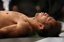 DENVER, CO - AUGUST 11:  Eiji Mitsuoka lies on the canvas before his bout against Nik Lentz at UFC 150 inside Pepsi Center on August 11, 2012 in Denver, Colorado. (Photo by Josh Hedges/Zuffa LLC/Zuffa LLC via Getty Images)