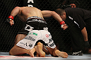 DENVER, CO - AUGUST 11:  Nik Lentz (black shorts) punches down at Eiji Mitsuoka during their featherweight bout at UFC 150 inside Pepsi Center on August 11, 2012 in Denver, Colorado. (Photo by Josh Hedges/Zuffa LLC/Zuffa LLC via Getty Images)