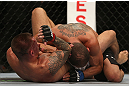 DENVER, CO - AUGUST 11:  (L-R) Dustin Pague delivers an elbow strike against Chico Camus on the ground during their bantamweight bout at UFC 150 inside Pepsi Center on August 11, 2012 in Denver, Colorado. (Photo by Josh Hedges/Zuffa LLC/Zuffa LLC via Getty Images)