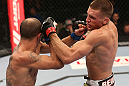 DENVER, CO - AUGUST 11:  (R-L) Dustin Pague punches Chico Camus during their bantamweight bout at UFC 150 inside Pepsi Center on August 11, 2012 in Denver, Colorado. (Photo by Nick Laham/Zuffa LLC/Zuffa LLC via Getty Images)