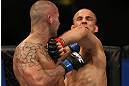 DENVER, CO - AUGUST 11:  (L-R) Michael Kuiper knocks down Jared Hamman with a punch during their middleweight bout at UFC 150 inside Pepsi Center on August 11, 2012 in Denver, Colorado. (Photo by Josh Hedges/Zuffa LLC/Zuffa LLC via Getty Images)