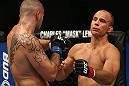 DENVER, CO - AUGUST 11:  (L-R) Michael Kuiper knocks down Jared Hamman with a punch during their middleweight bout at UFC 150 inside Pepsi Center on August 11, 2012 in Denver, Colorado. (Photo by Josh Hedges/Zuffa LLC/Zuffa LLC via Getty Images)