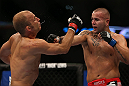 DENVER, CO - AUGUST 11:  (R-L) Michael Kuiper knocks down Jared Hamman with a punch during their middleweight bout at UFC 150 inside Pepsi Center on August 11, 2012 in Denver, Colorado. (Photo by Josh Hedges/Zuffa LLC/Zuffa LLC via Getty Images)