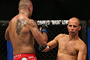 DENVER, CO - AUGUST 11:  (L-R) Michael Kuiper knocks down Jared Hamman with a punch during their middleweight bout at UFC 150 inside Pepsi Center on August 11, 2012 in Denver, Colorado. (Photo by Josh Hedges/Zuffa LLC/Zuffa LLC via Getty Images)