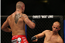 DENVER, CO - AUGUST 11:  (L-R) Michael Kuiper knocks down Jared Hamman with a punch during their middleweight bout at UFC 150 inside Pepsi Center on August 11, 2012 in Denver, Colorado. (Photo by Josh Hedges/Zuffa LLC/Zuffa LLC via Getty Images)