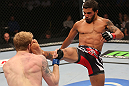 DENVER, CO - AUGUST 11:  (R-L) Dennis Bermudez kicks Tommy Hayden during their featherweight bout at UFC 150 inside Pepsi Center on August 11, 2012 in Denver, Colorado. (Photo by Nick Laham/Zuffa LLC/Zuffa LLC via Getty Images)