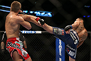 DENVER, CO - AUGUST 11:  (R-L) Max Holloway kicks Justin Lawrence during their featherweight bout at UFC 150 inside Pepsi Center on August 11, 2012 in Denver, Colorado. (Photo by Josh Hedges/Zuffa LLC/Zuffa LLC via Getty Images)