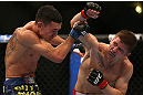 DENVER, CO - AUGUST 11:  (R-L) Justin Lawrence punches Max Holloway during their featherweight bout at UFC 150 inside Pepsi Center on August 11, 2012 in Denver, Colorado. (Photo by Josh Hedges/Zuffa LLC/Zuffa LLC via Getty Images)