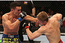 DENVER, CO - AUGUST 11:  (L-R) Max Holloway punches Justin Lawrence during their featherweight bout at UFC 150 inside Pepsi Center on August 11, 2012 in Denver, Colorado. (Photo by Nick Laham/Zuffa LLC/Zuffa LLC via Getty Images)