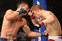 DENVER, CO - AUGUST 11:  (L-R) Max Holloway punches Justin Lawrence during their featherweight bout at UFC 150 inside Pepsi Center on August 11, 2012 in Denver, Colorado. (Photo by Nick Laham/Zuffa LLC/Zuffa LLC via Getty Images)