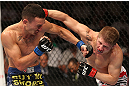 DENVER, CO - AUGUST 11:  (L-R) Max Holloway and Justin Lawrence trade punches during their featherweight bout at UFC 150 inside Pepsi Center on August 11, 2012 in Denver, Colorado. (Photo by Nick Laham/Zuffa LLC/Zuffa LLC via Getty Images)
