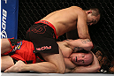 DENVER, CO - AUGUST 11:  Yushin Okami (top) punches down at Buddy Roberts during their middleweight bout at UFC 150 inside Pepsi Center on August 11, 2012 in Denver, Colorado. (Photo by Josh Hedges/Zuffa LLC/Zuffa LLC via Getty Images)