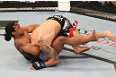 DENVER, CO - AUGUST 11:  (R-L) Benson Henderson attempts a guillotine choke submission against Frankie Edgar during their lightweight championship bout at UFC 150 inside Pepsi Center on August 11, 2012 in Denver, Colorado. (Photo by Nick Laham/Zuffa LLC/Zuffa LLC via Getty Images)