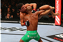 TORONTO, CANADA - SEPTEMBER 22: Demetrious Johnson (green shorts) takes down Joseph Benavidez during their flyweight championship bout at UFC 152 inside Air Canada Centre on September 22, 2012 in Toronto, Ontario, Canada. (Photo by Al Bello/Zuffa LLC/Zuffa LLC via Getty Images)
