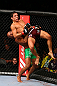 TORONTO, CANADA - SEPTEMBER 22: Demetrious Johnson (green shorts) takes down Joseph Benavidez during their flyweight championship bout at UFC 152 inside Air Canada Centre on September 22, 2012 in Toronto, Ontario, Canada. (Photo by Al Bello/Zuffa LLC/Zuffa LLC via Getty Images)