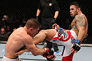 NOTTINGHAM, ENGLAND - SEPTEMBER 29:  (R-L) Brad Tavares kicks Tom Watson during their middleweight fight at the UFC on Fuel TV event at Capital FM Arena on September 29, 2012 in Nottingham, England.  (Photo by Josh Hedges/Zuffa LLC/Zuffa LLC via Getty Images)