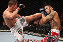 NOTTINGHAM, ENGLAND - SEPTEMBER 29:  (L-R) Tom Watson kicks Brad Tavares during their middleweight fight at the UFC on Fuel TV event at Capital FM Arena on September 29, 2012 in Nottingham, England.  (Photo by Josh Hedges/Zuffa LLC/Zuffa LLC via Getty Images)