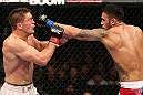 NOTTINGHAM, ENGLAND - SEPTEMBER 29:  (R-L) Brad Tavares punches Tom Watson during their middleweight fight at the UFC on Fuel TV event at Capital FM Arena on September 29, 2012 in Nottingham, England.  (Photo by Josh Hedges/Zuffa LLC/Zuffa LLC via Getty Images)
