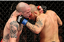 NOTTINGHAM, ENGLAND - SEPTEMBER 29:  (R-L) Akira Corassani punches Andy Ogle during their featherweight fight at the UFC on Fuel TV event at Capital FM Arena on September 29, 2012 in Nottingham, England.  (Photo by Josh Hedges/Zuffa LLC/Zuffa LLC via Getty Images)
