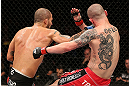 NOTTINGHAM, ENGLAND - SEPTEMBER 29:  (L-R) Akira Corassani punches Andy Ogle during their featherweight fight at the UFC on Fuel TV event at Capital FM Arena on September 29, 2012 in Nottingham, England.  (Photo by Josh Hedges/Zuffa LLC/Zuffa LLC via Getty Images)