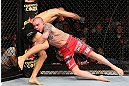 NOTTINGHAM, ENGLAND - SEPTEMBER 29:  (R-L) Andy Ogle takes down Akira Corassani during their featherweight fight at the UFC on Fuel TV event at Capital FM Arena on September 29, 2012 in Nottingham, England.  (Photo by Josh Hedges/Zuffa LLC/Zuffa LLC via Getty Images)