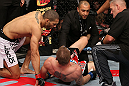 NOTTINGHAM, ENGLAND - SEPTEMBER 29:  (L-R) Che Mills checks on opponent Duane Ludwig after Ludwig suffered a knee injury during their welterweight fight at the UFC on Fuel TV event at Capital FM Arena on September 29, 2012 in Nottingham, England.  (Photo by Josh Hedges/Zuffa LLC/Zuffa LLC via Getty Images)