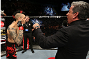 NOTTINGHAM, ENGLAND - SEPTEMBER 29:  Dan Hardy (L) is introduced by Bruce Buffer before his welterweight fight against Amir Sadollah at the UFC on Fuel TV event at Capital FM Arena on September 29, 2012 in Nottingham, England.  (Photo by Josh Hedges/Zuffa LLC/Zuffa LLC via Getty Images)