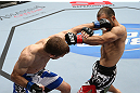 MINNEAPOLIS, MN - OCTOBER 05:  (L-R) Phil Harris punches Darren Uyenoyama during their flyweight fight at the UFC on FX event at Target Center on October 5, 2012 in Minneapolis, Minnesota.  (Photo by Josh Hedges/Zuffa LLC/Zuffa LLC via Getty Images)