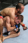 MINNEAPOLIS, MN - OCTOBER 05:  (L-R) Darren Uyenoyama secures a rear choke submission against Phil Harris during their flyweight fight at the UFC on FX event at Target Center on October 5, 2012 in Minneapolis, Minnesota.  (Photo by Josh Hedges/Zuffa LLC/Zuffa LLC via Getty Images)