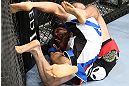 MINNEAPOLIS, MN - OCTOBER 05:  (R-L) Darren Uyenoyama secures a rear choke submission against Phil Harris during their flyweight fight at the UFC on FX event at Target Center on October 5, 2012 in Minneapolis, Minnesota.  (Photo by Josh Hedges/Zuffa LLC/Zuffa LLC via Getty Images)