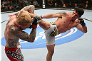 MINNEAPOLIS, MN - OCTOBER 05:  (R-L) Diego Nunes kicks Bart Palaszewski during their featherweight fight at the UFC on FX event at Target Center on October 5, 2012 in Minneapolis, Minnesota.  (Photo by Josh Hedges/Zuffa LLC/Zuffa LLC via Getty Images)