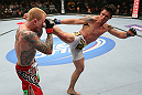 MINNEAPOLIS, MN - OCTOBER 05:  (R-L) Diego Nunes kicks Bart Palaszewski during their featherweight fight at the UFC on FX event at Target Center on October 5, 2012 in Minneapolis, Minnesota.  (Photo by Josh Hedges/Zuffa LLC/Zuffa LLC via Getty Images)