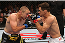 MINNEAPOLIS, MN - OCTOBER 05:  (R-L) Aaron Simpson punches Mike Pierce during their welterweight fight at the UFC on FX event at Target Center on October 5, 2012 in Minneapolis, Minnesota.  (Photo by Josh Hedges/Zuffa LLC/Zuffa LLC via Getty Images)
